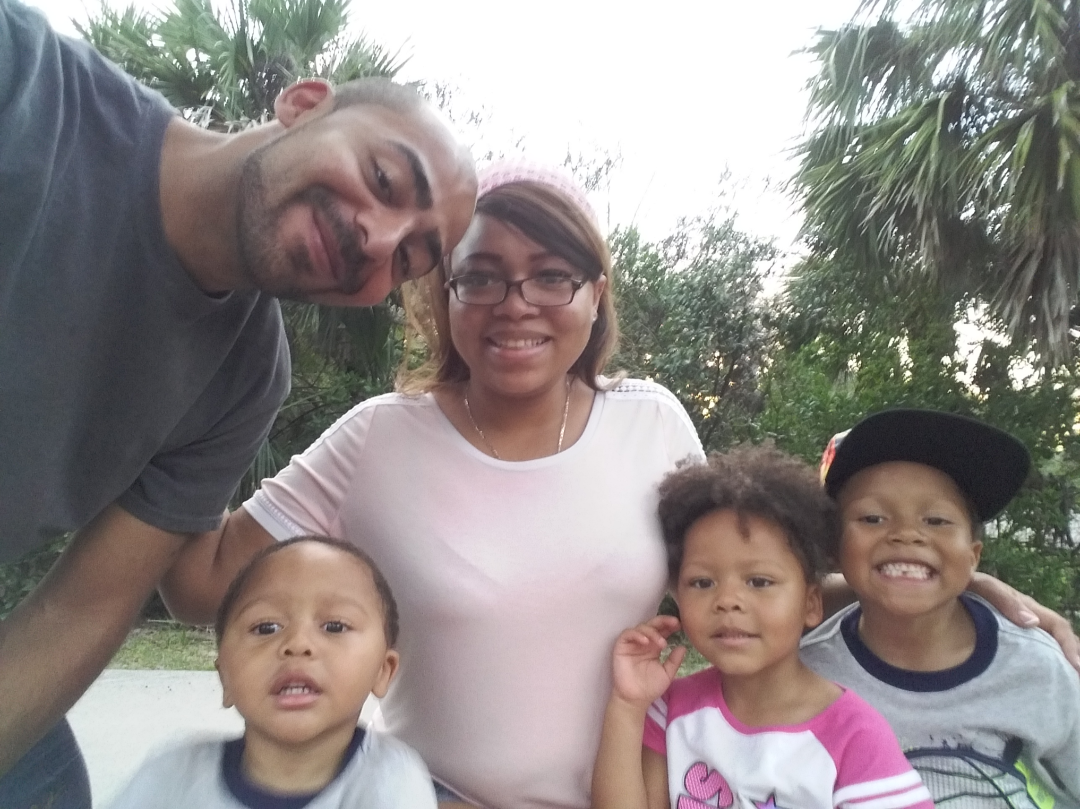 A family of five immigrants poses for a group selfie outside in Florida