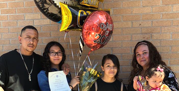 Family of five, including 3 girls, poses for a picture at one of the girls' 8th grade promotion celebration